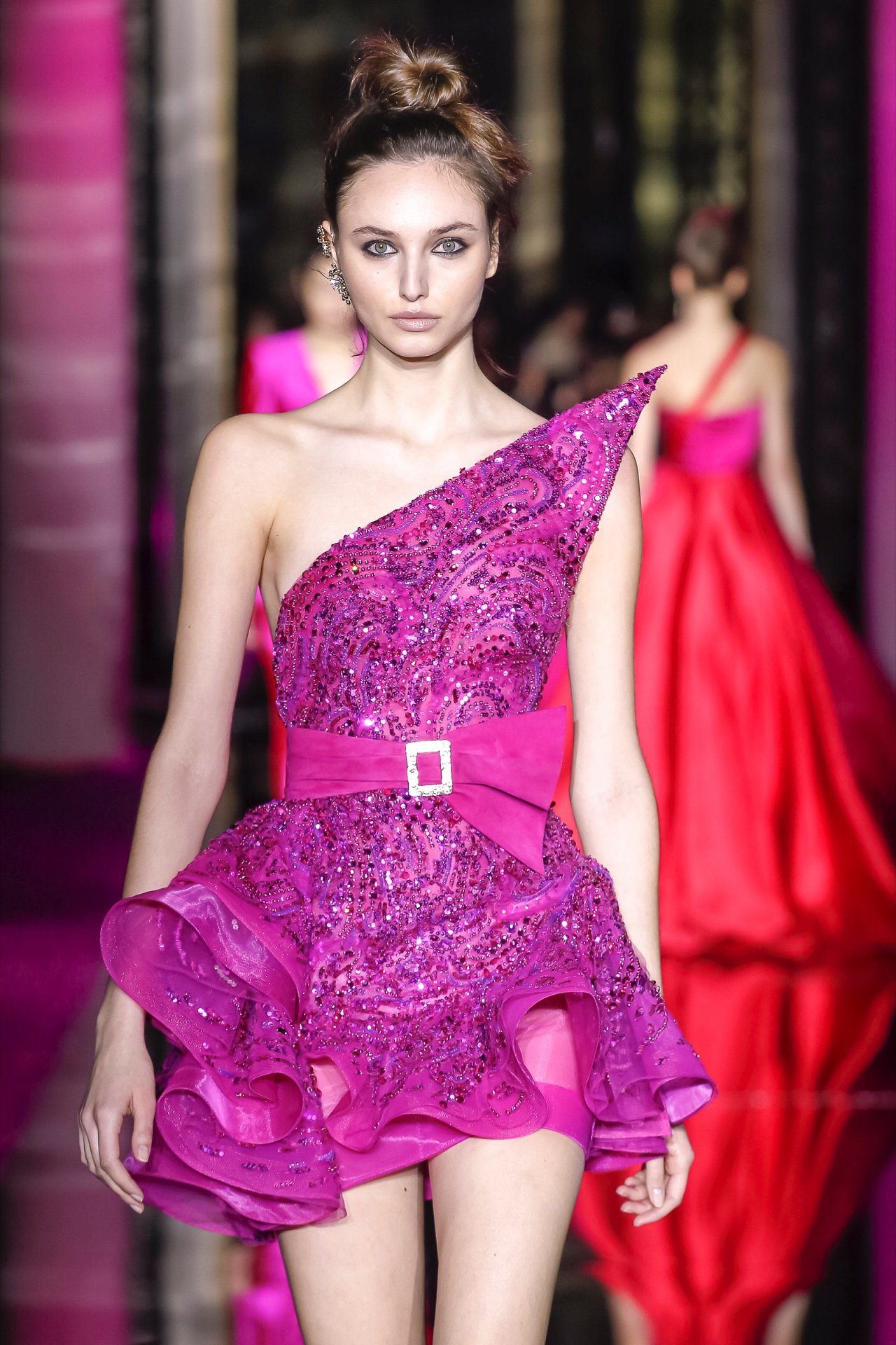 Long dress rendered in fuchsia lace showered with pink crystals